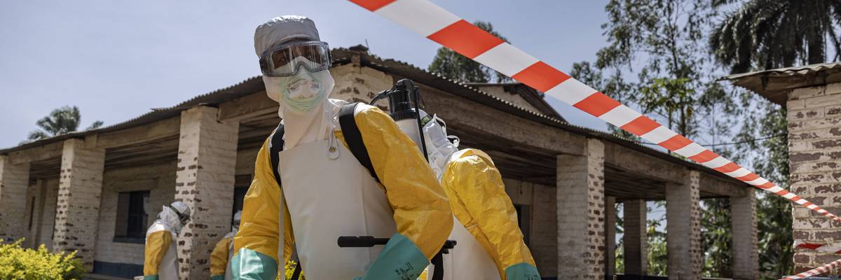A health worker disinfects an area during the Ebola outbreak in Congo.