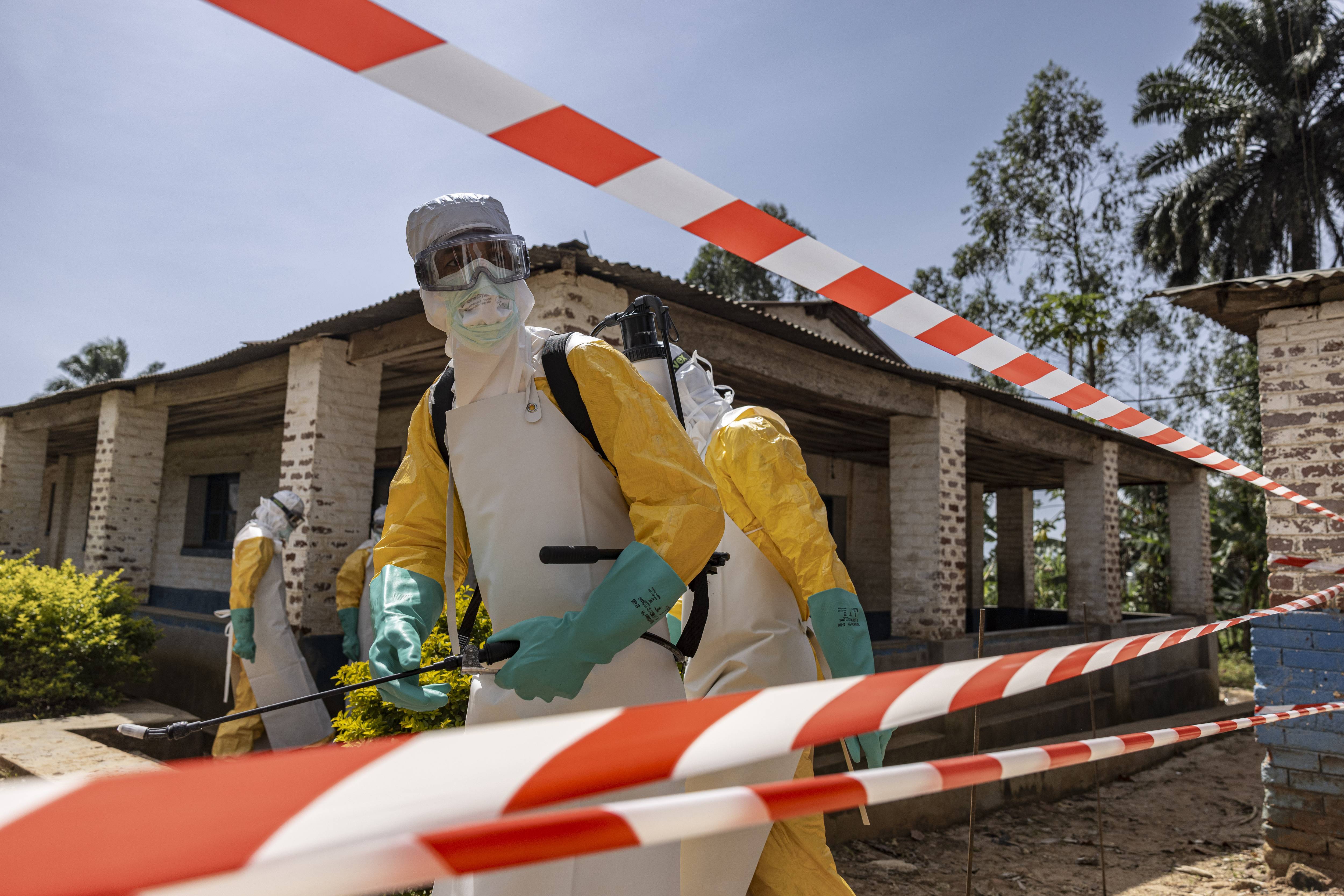 A health worker disinfects an area during the Ebola outbreak in Congo.