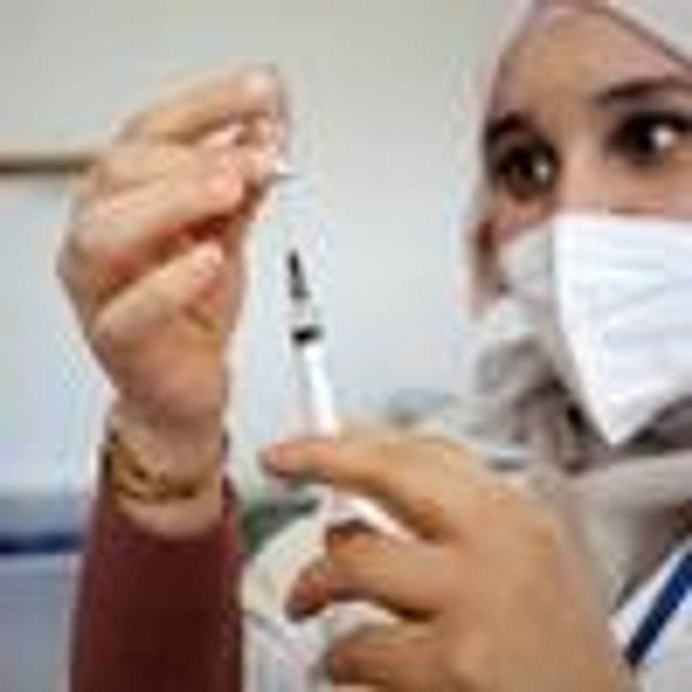 A health worker prepares a coronavirus vaccine dose
