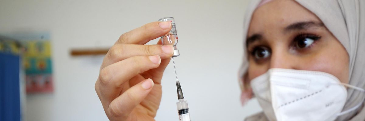 A health worker prepares a coronavirus vaccine dose