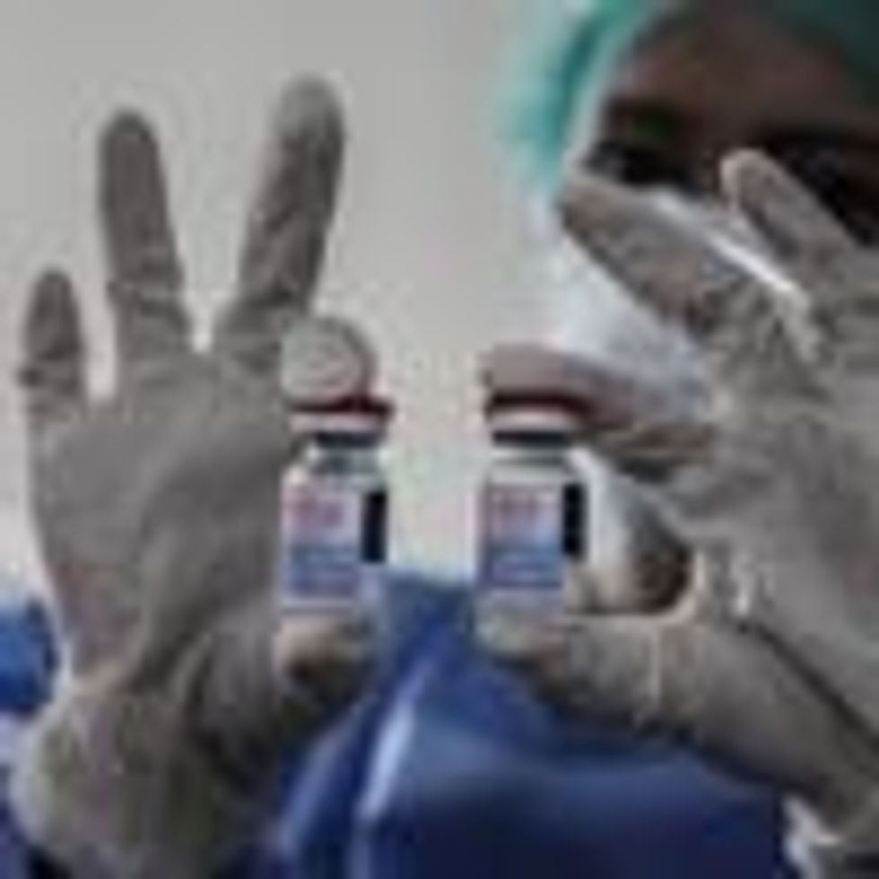 A healthcare professional holds vials of the Moderna vaccine
