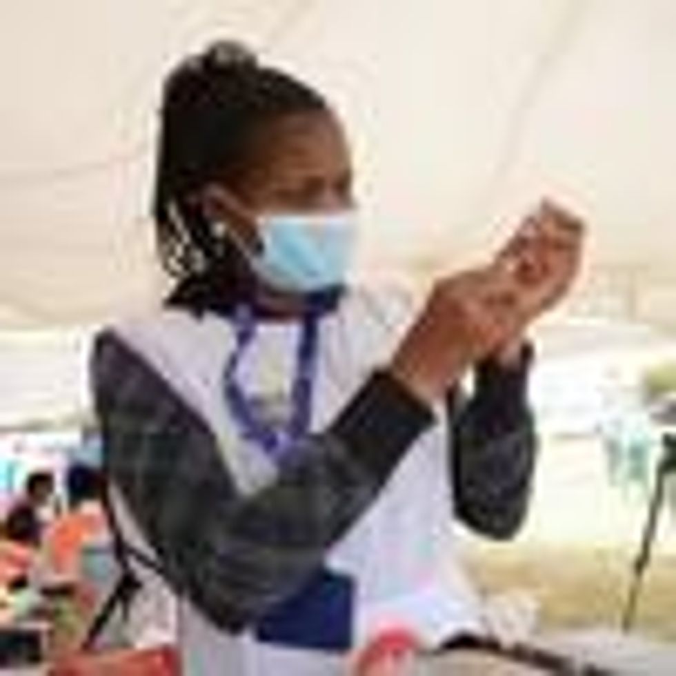 A healthcare worker prepares a coronavirus vaccine dose
