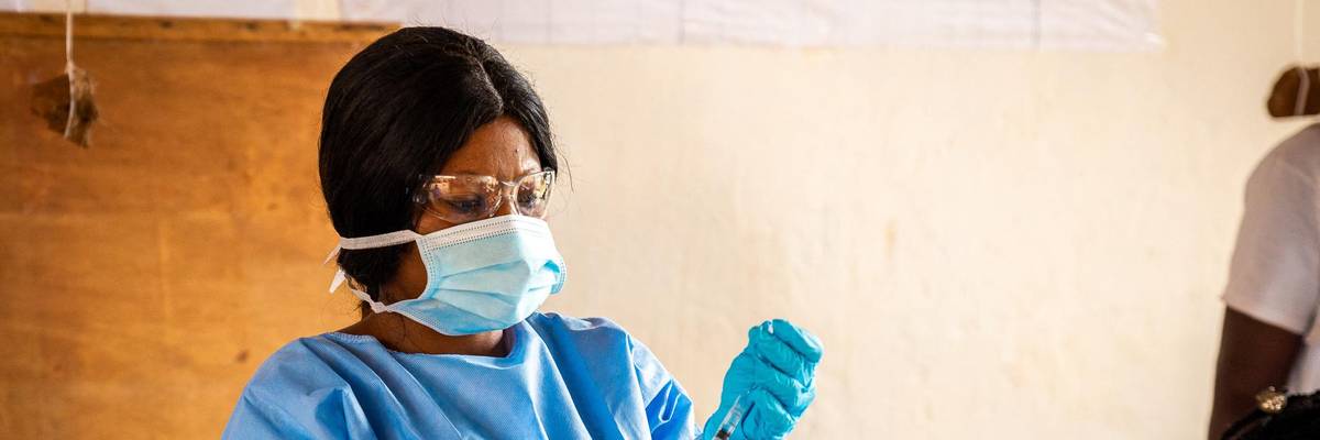 A healthcare worker prepares a coronavirus vaccine dose.