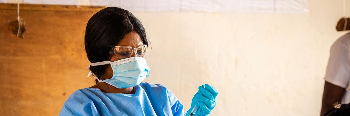 A healthcare worker prepares a coronavirus vaccine dose.