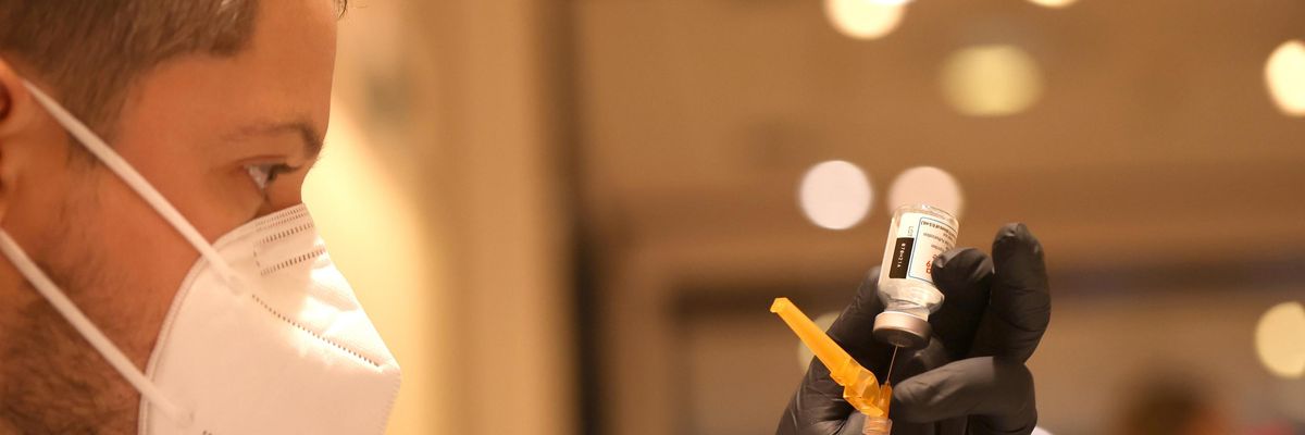 A healthcare worker prepares a Covid-19 vaccine