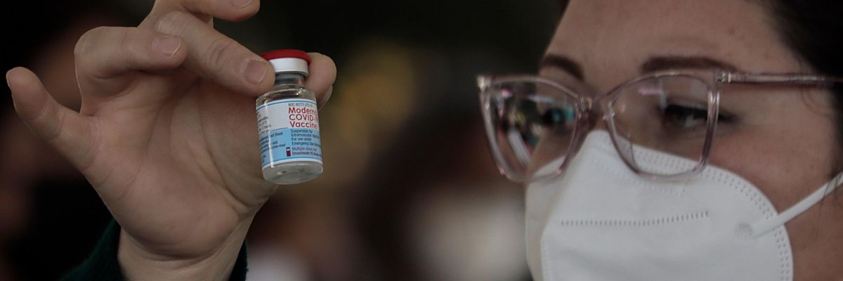 A healthcare worker prepares to vaccinate teachers against Covid-19