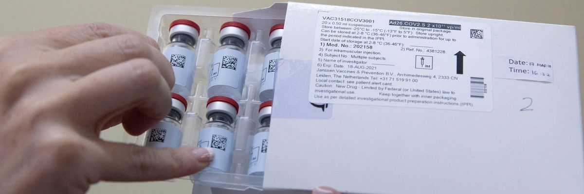 A healthcare workers holds vials of vaccine