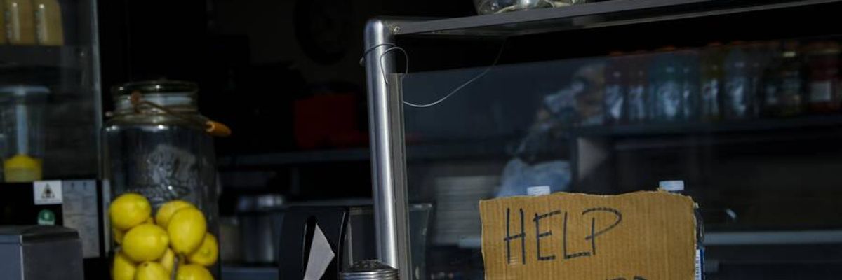 A "help wanted" sign is seen at a restaurant