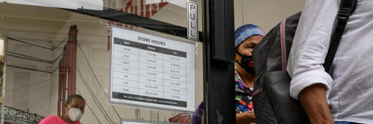 A hiring sign is displayed at a retail store in New York
