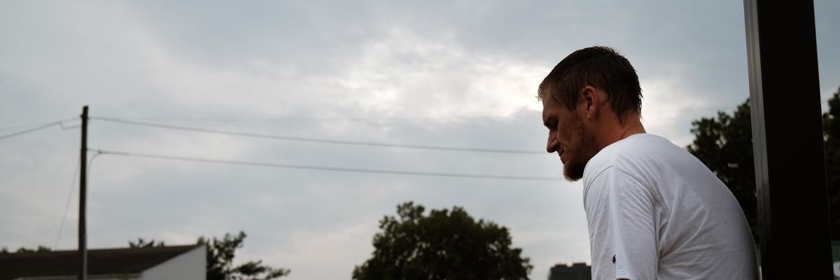 A homeless man named Caleb  sits on a street corner on August 5, 2021 in Springfield, Missouri.