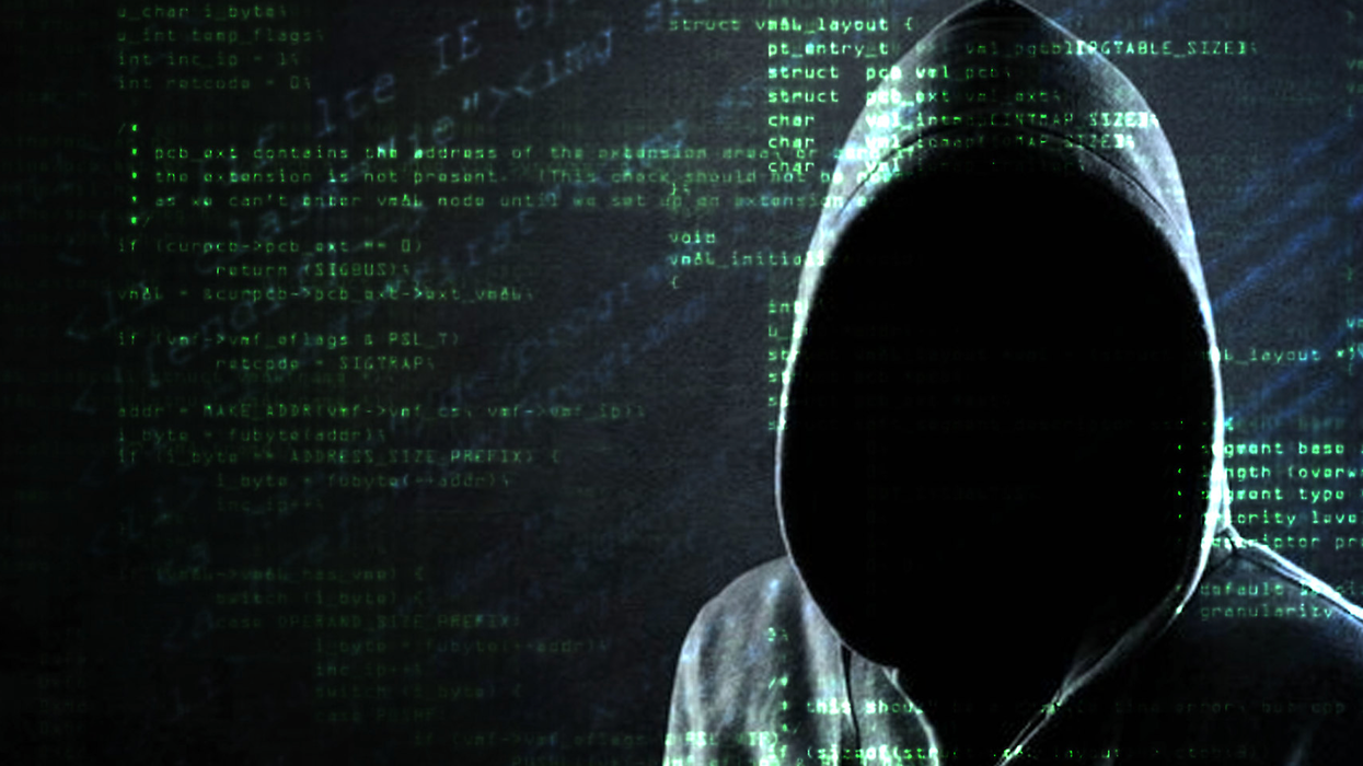 A hooded, shadowy figure is set against a backdrop of computer code in this animated image.