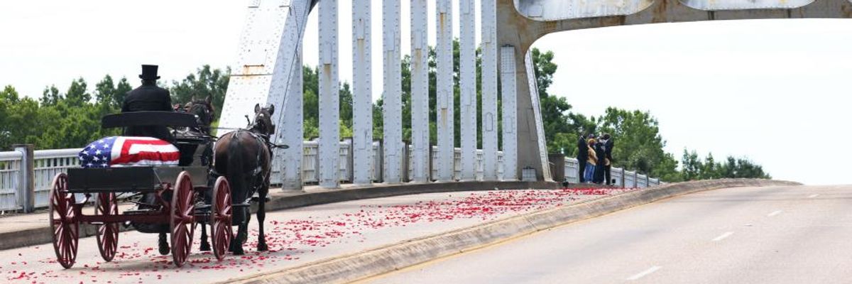 A horse-drawn carriage carrying the body Rep. John Lewis (D-Ga.) crosses the Edmund Pettus Bridge on July 26, 2020 in Selma, Alabama.