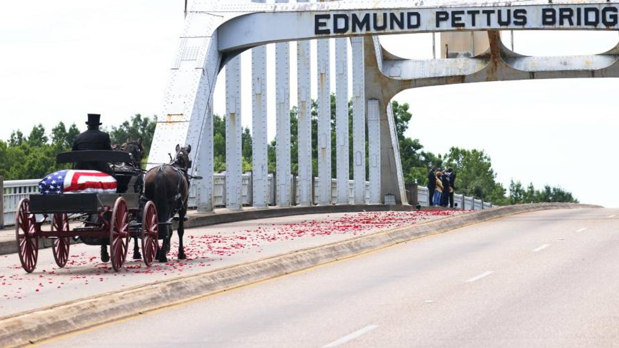 A horse-drawn carriage carrying the body Rep. John Lewis (D-Ga.) crosses the Edmund Pettus Bridge on July 26, 2020 in Selma, Alabama.