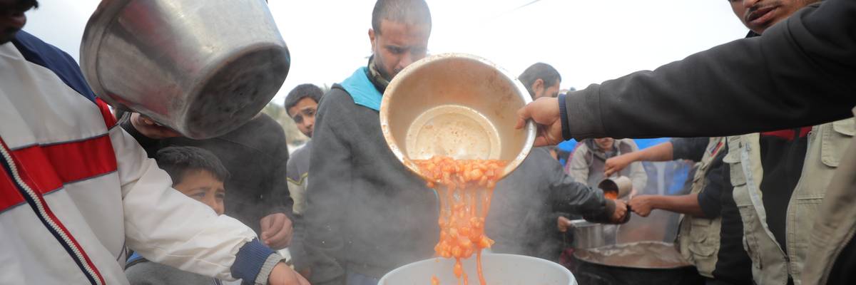 a hot meal distribution in the Nuseirat refugee camp.