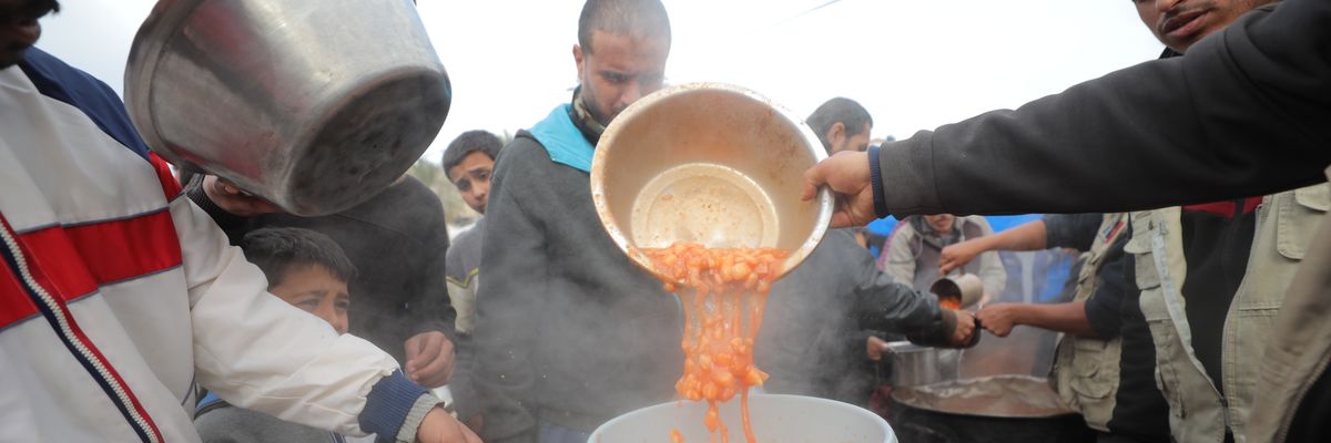 a hot meal distribution in the Nuseirat refugee camp.