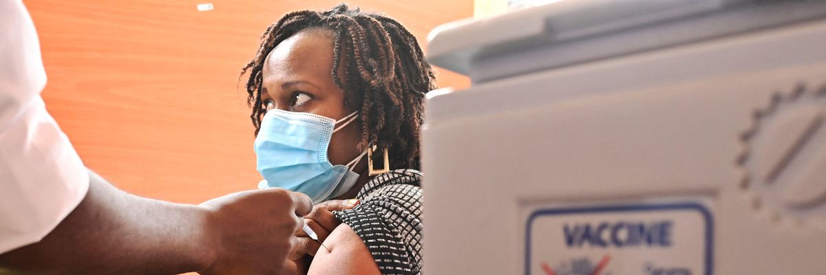 A Kenyan woman receives an injection