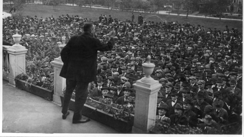 A labor leader speaks on s stage during a strike. 