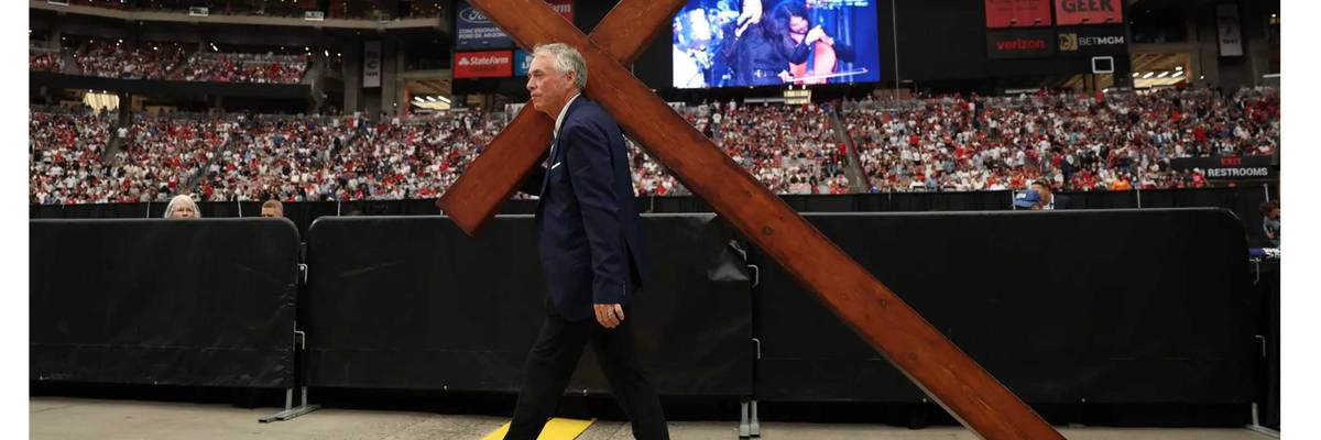 A large cross is wheeled in for Charlie Kirk memorial in Arizona