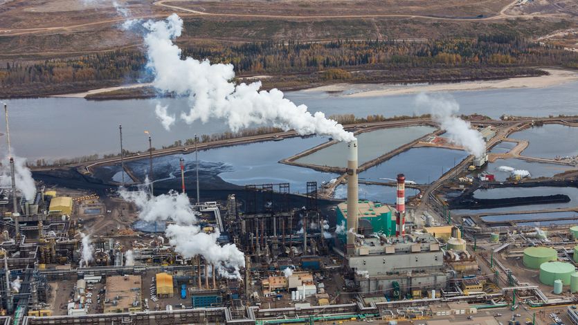A large oil refinery is shown along the Athabasca River in Alberta, Canada.