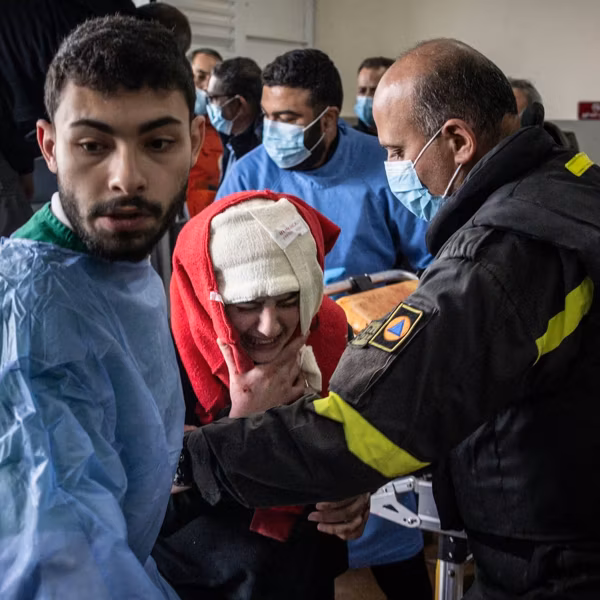 A Lebanese woman injured by an Israeli airstrike arrives in a hospital with her head bandaged