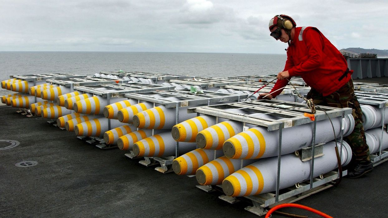 A load of 500-pound bombs is secured