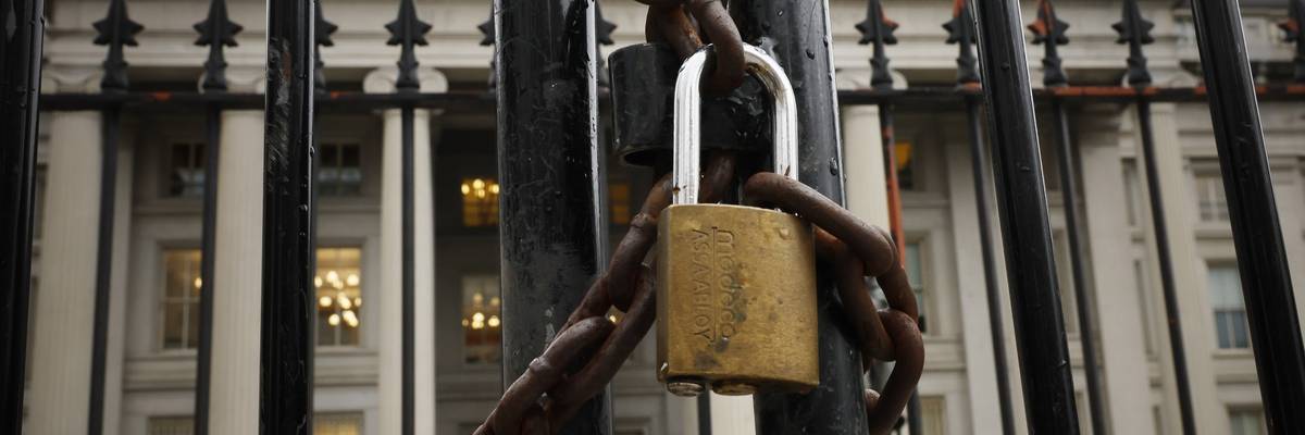 A lock is seen on a gate on the exterior of the U.S. Department of Treasury