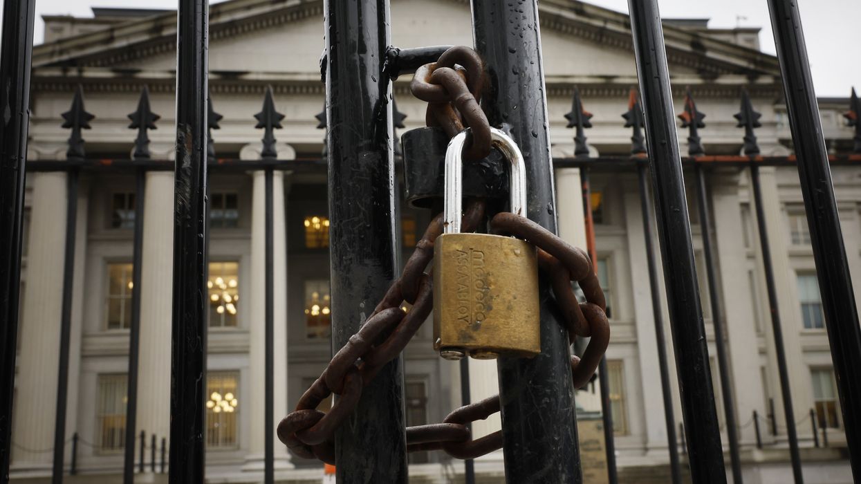 A lock is seen on a gate on the exterior of the U.S. Department of Treasury
