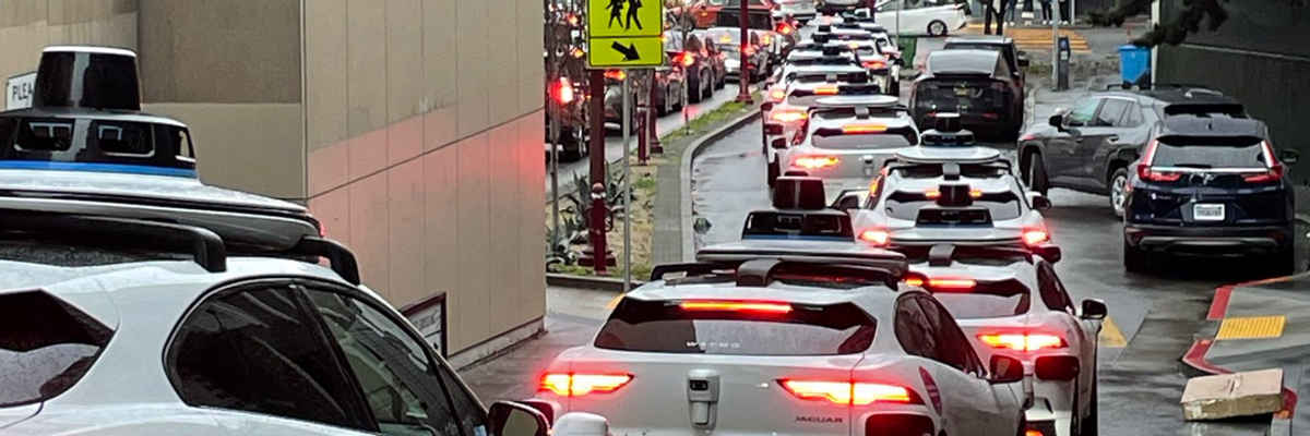 A long line of Waymo robotaxis snarls traffic in San Francisco