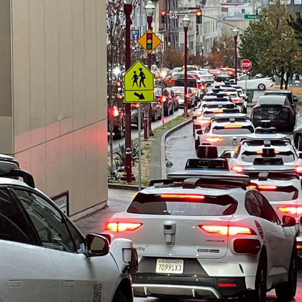 A long line of Waymo robotaxis snarls traffic in San Francisco