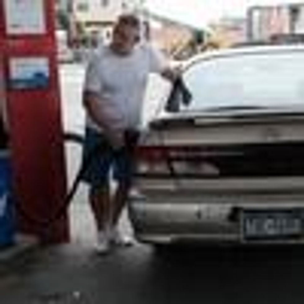 A man fills his car's gas tank