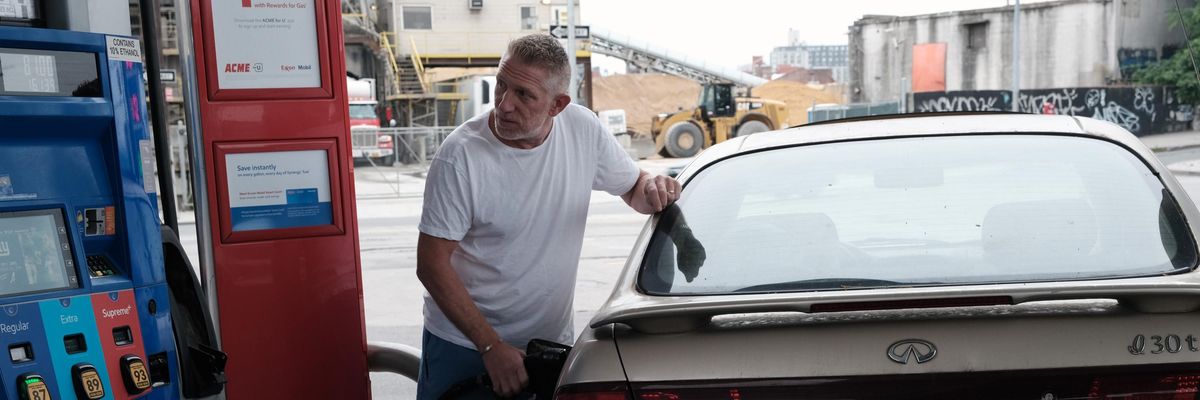 A man fills his car's gas tank