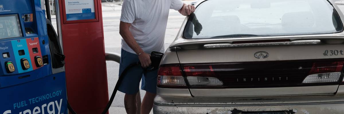 A man fills his car with gas.