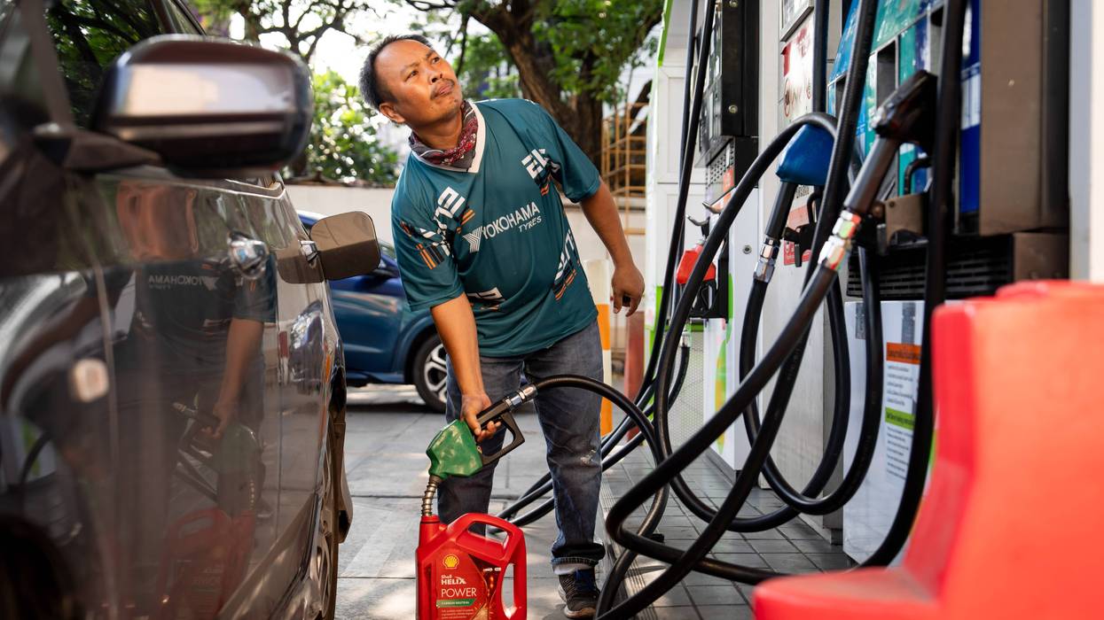 A man gets gas in Thailand.