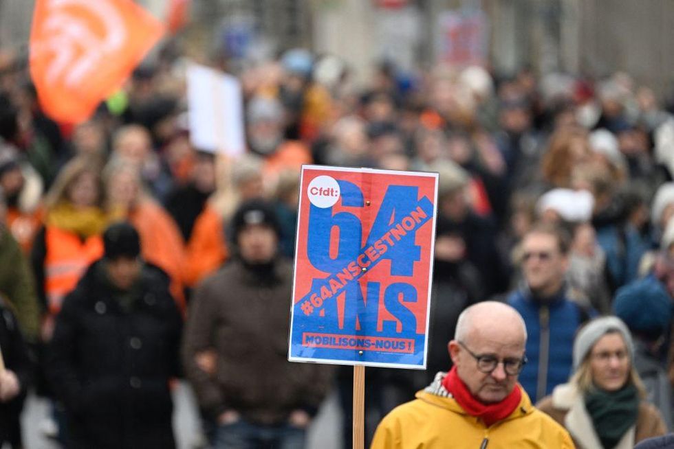 A man holding up a placard that read, '64years it's no'