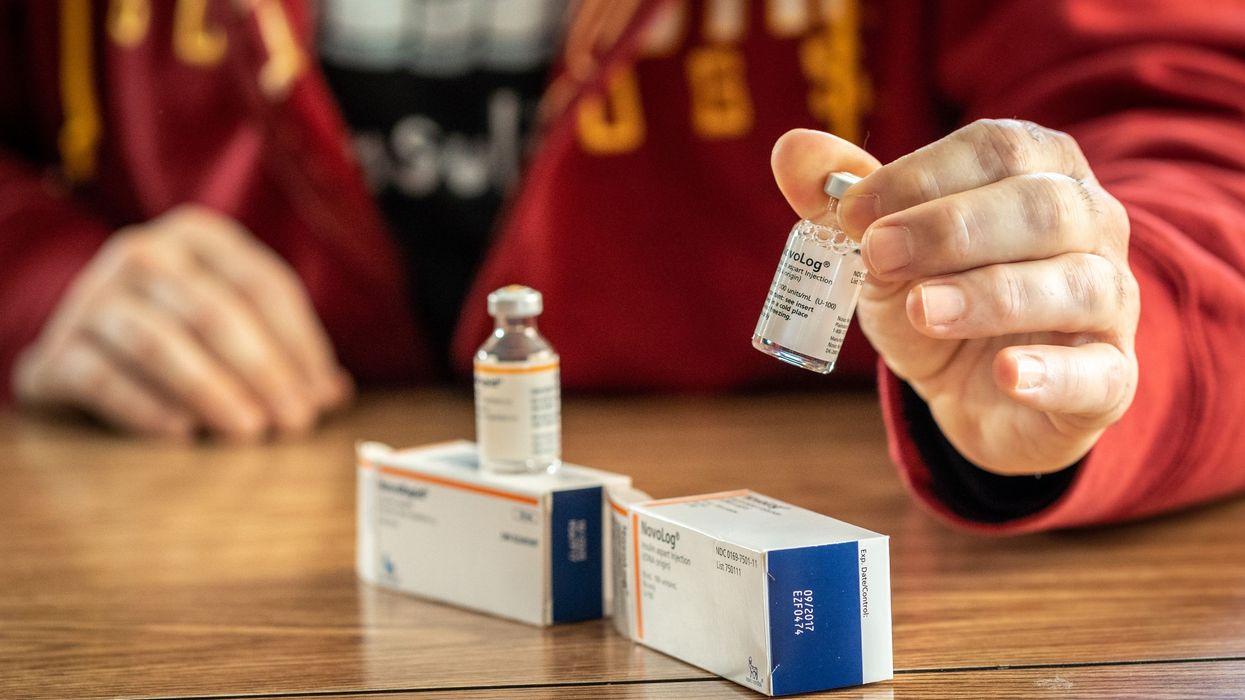 A man looks at NovoRapid, a Canadian insulin medication, and NovoLog, the U.S. version,