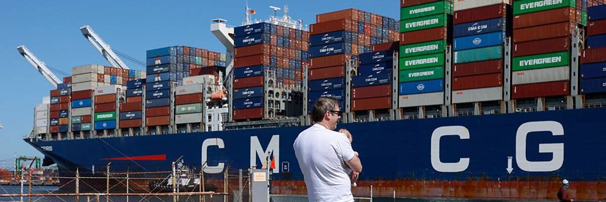 A man looks on as the container ship CMA CGM Osiris arrives at the Port of Oakland on April 9, 2025 in Oakland, California. U.S.