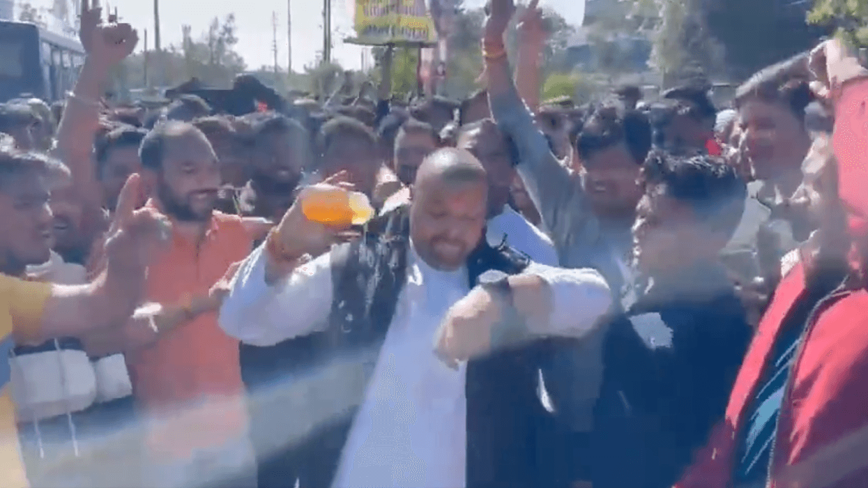 A man pours liquid on himself before being set on fire in an apparent self-immolation protest