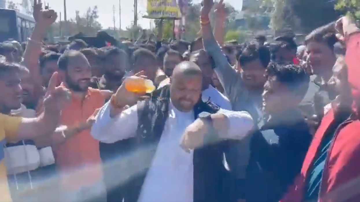 A man pours liquid on himself before being set on fire in an apparent self-immolation protest