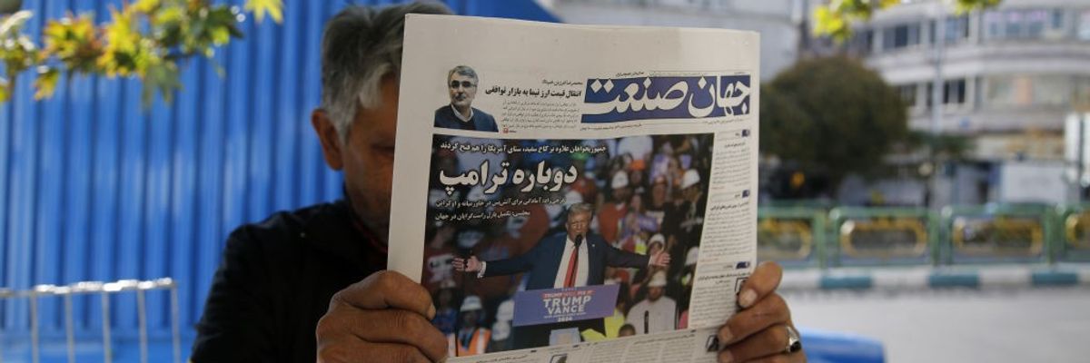 A man reads a newspaper with a story about the U.S. presidential election