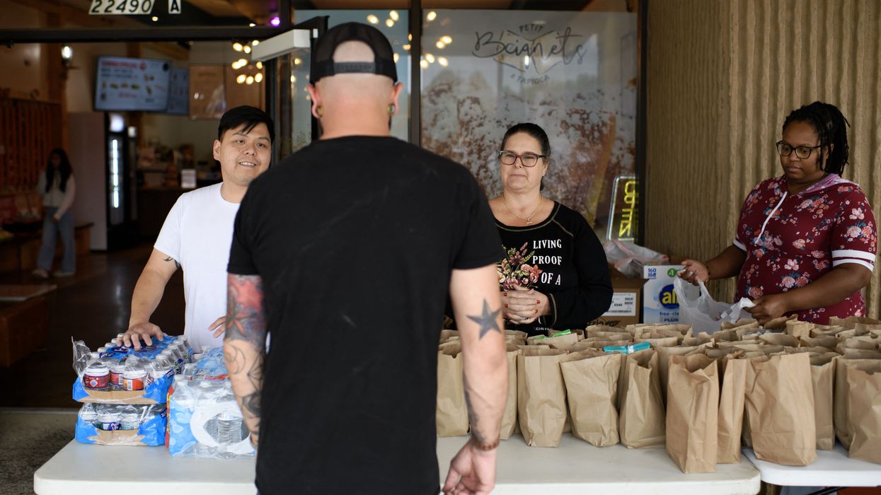 A man receives a free lunch bag in Houston
