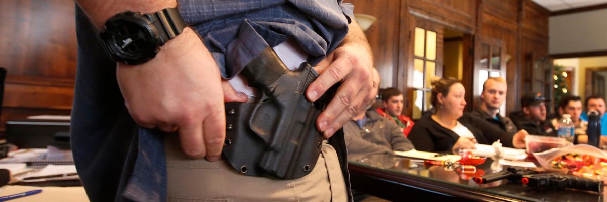A man shows a gun holdster