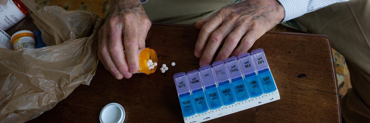 A man sorts prescription pills