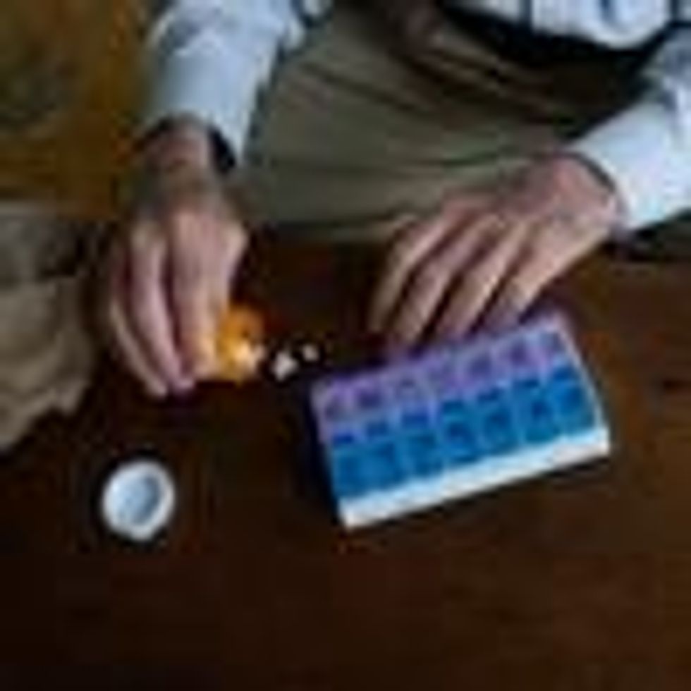 A man sorts prescription pills