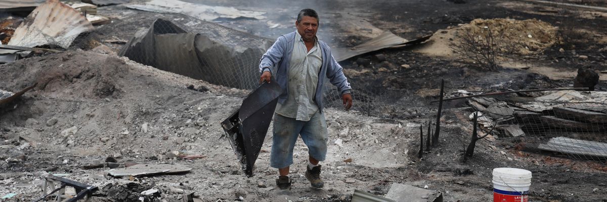 A man stands in the ruins of Chile wildfires.