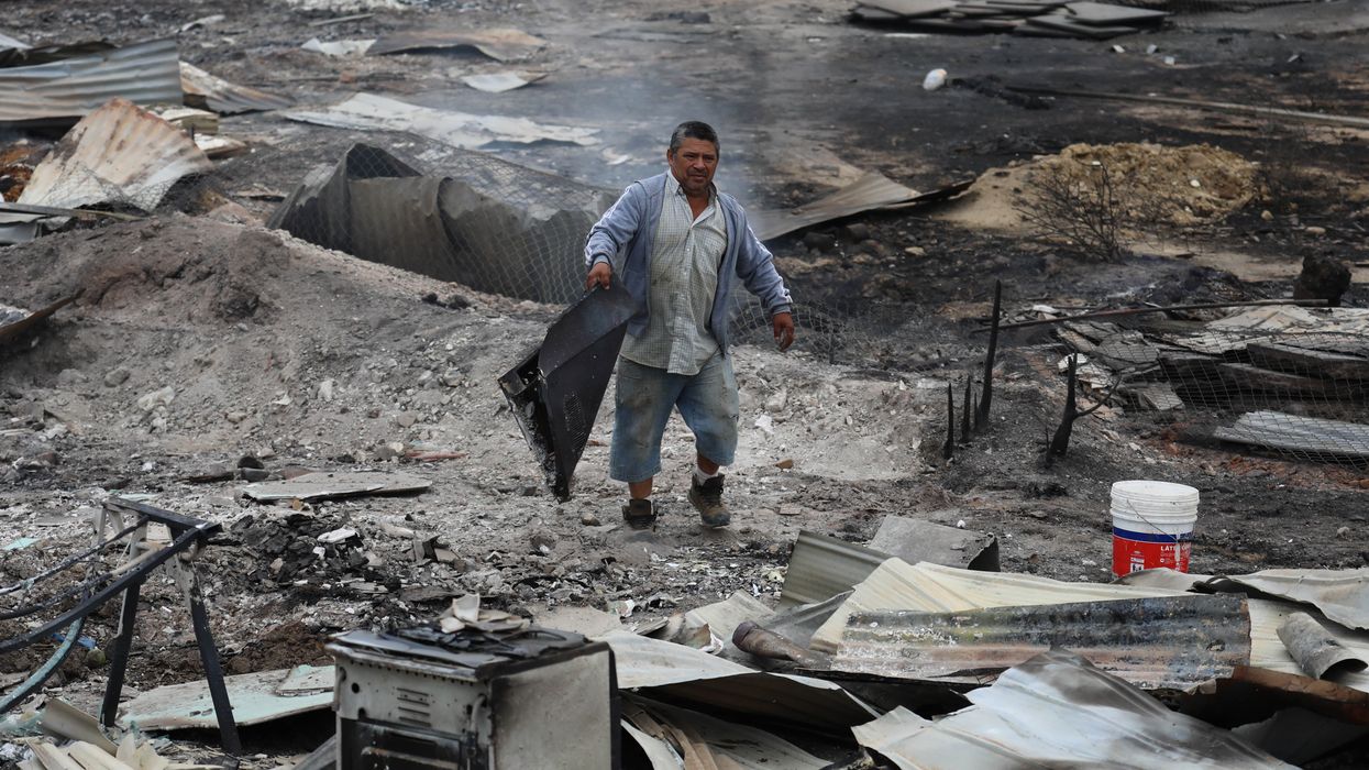 A man stands in the ruins of Chile wildfires.