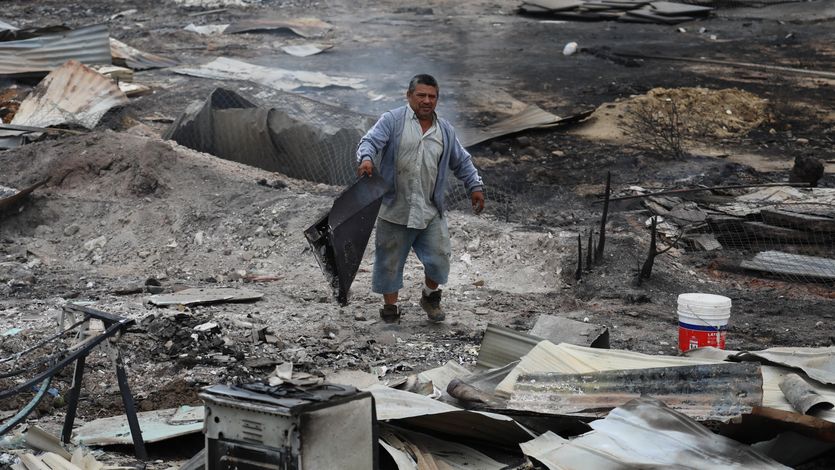 A man stands in the ruins of Chile wildfires.