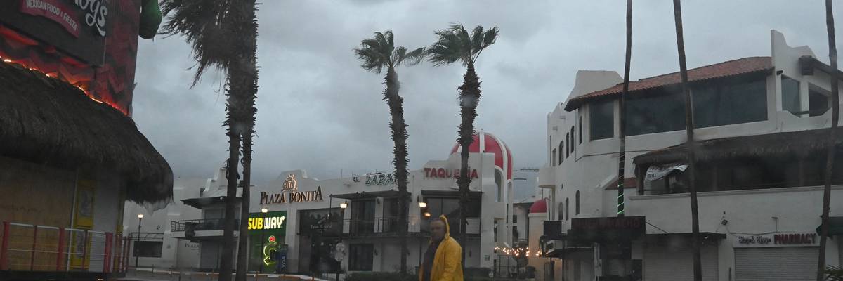 A man walks along a street in Cabo San Lucas, Baja California State, Mexico
