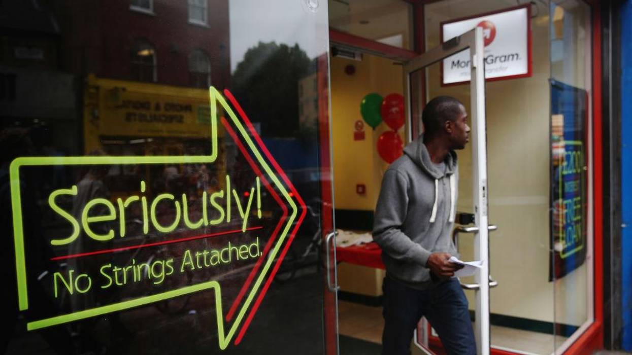 A man walks out of a payday loan store.