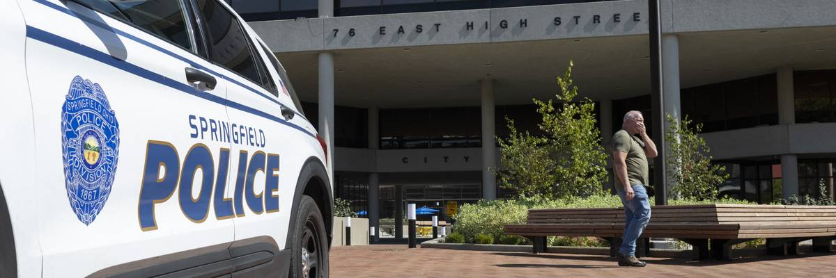 A man walks past the Springfield City Hall