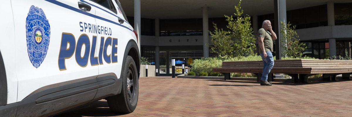 A man walks past the Springfield City Hall
